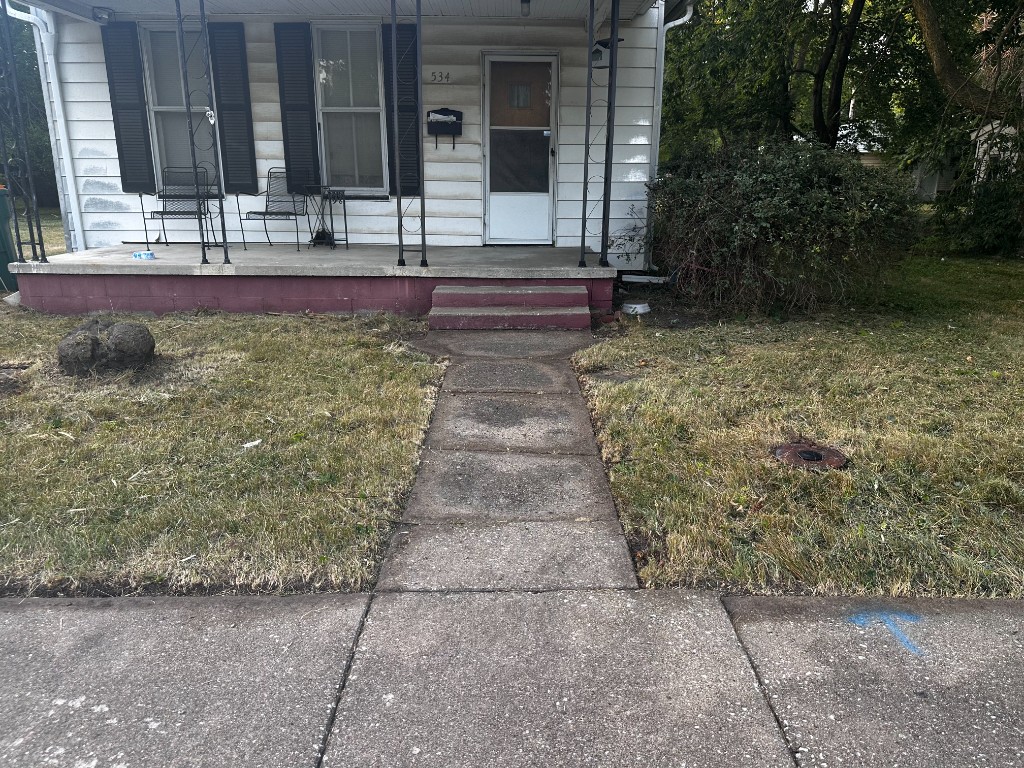 After: same Macomb, IL property with the walkway cleared and the lawn cut back