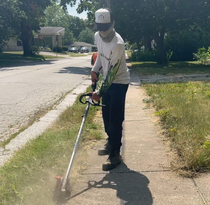 A Belle and Brothers crew member edging a sidewalk in Macomb, Illinois